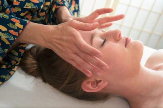 Organic facial treatment on woman's temples