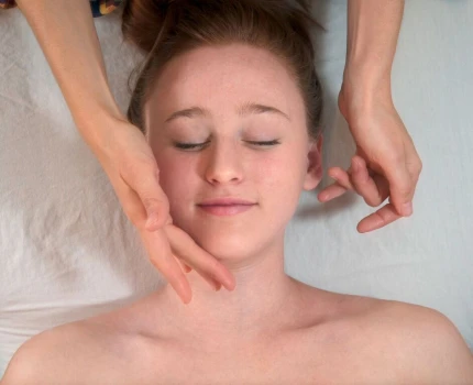 Woman smiling as she gets an organic facial